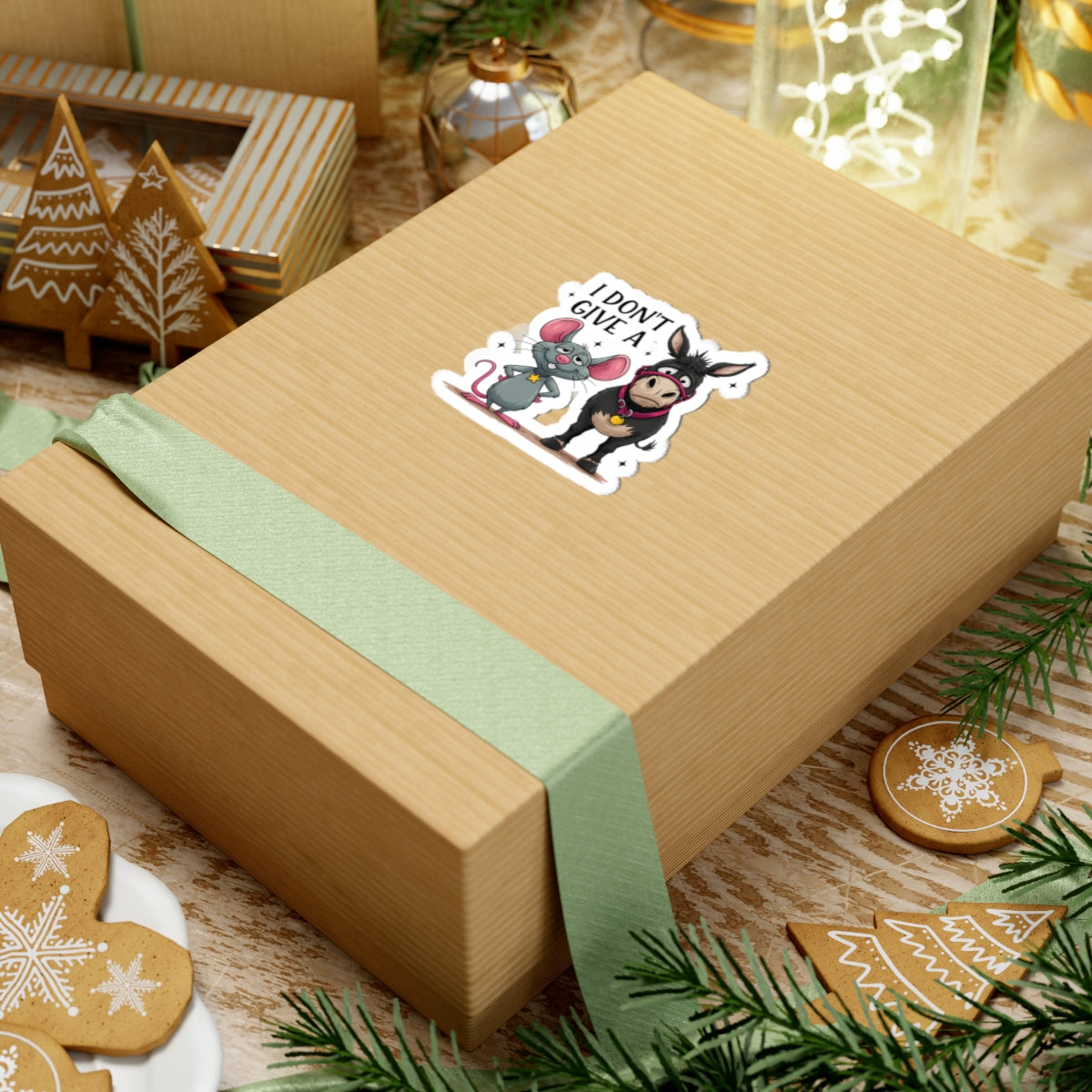 Gift box with a sticker featuring cartoon characters on a festive background with cookies and decorations.