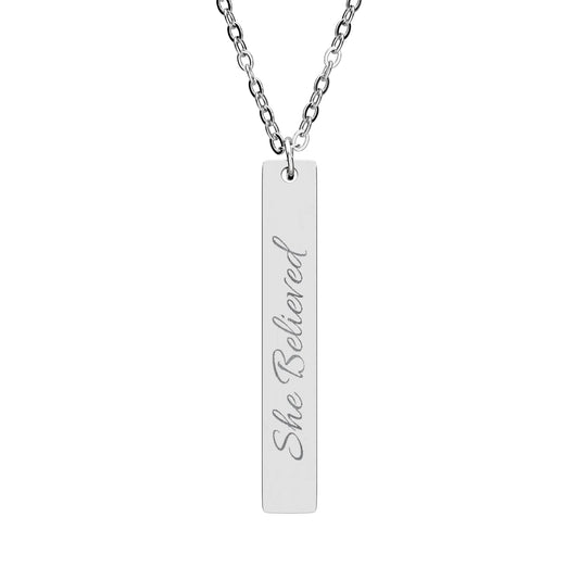 "She Believed" Vertical Bar Necklace - Inspirational jewelry in silver, gold, and rose gold featuring a simple bar pendant with the empowering message "She Believed" engraved on it.