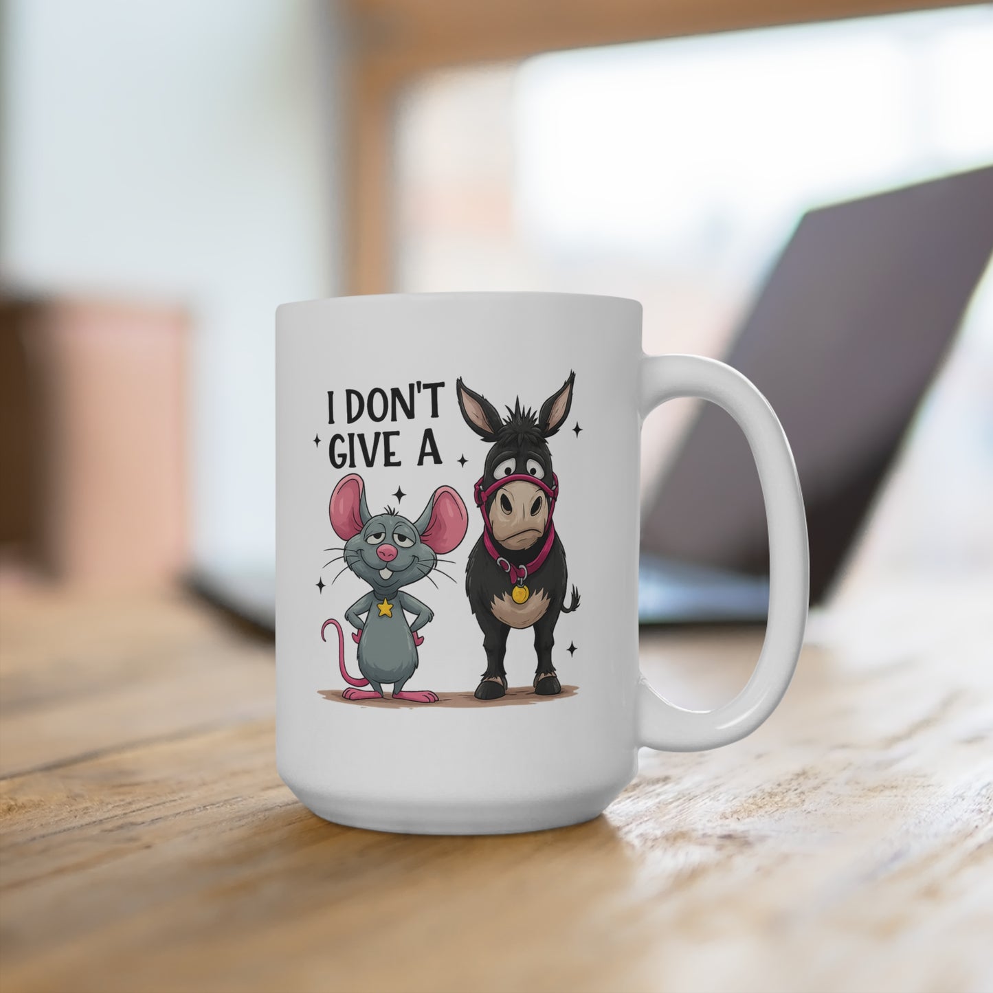 White mug with cartoon mouse and donkey design and text 'I Don't Give A' on a wooden surface.