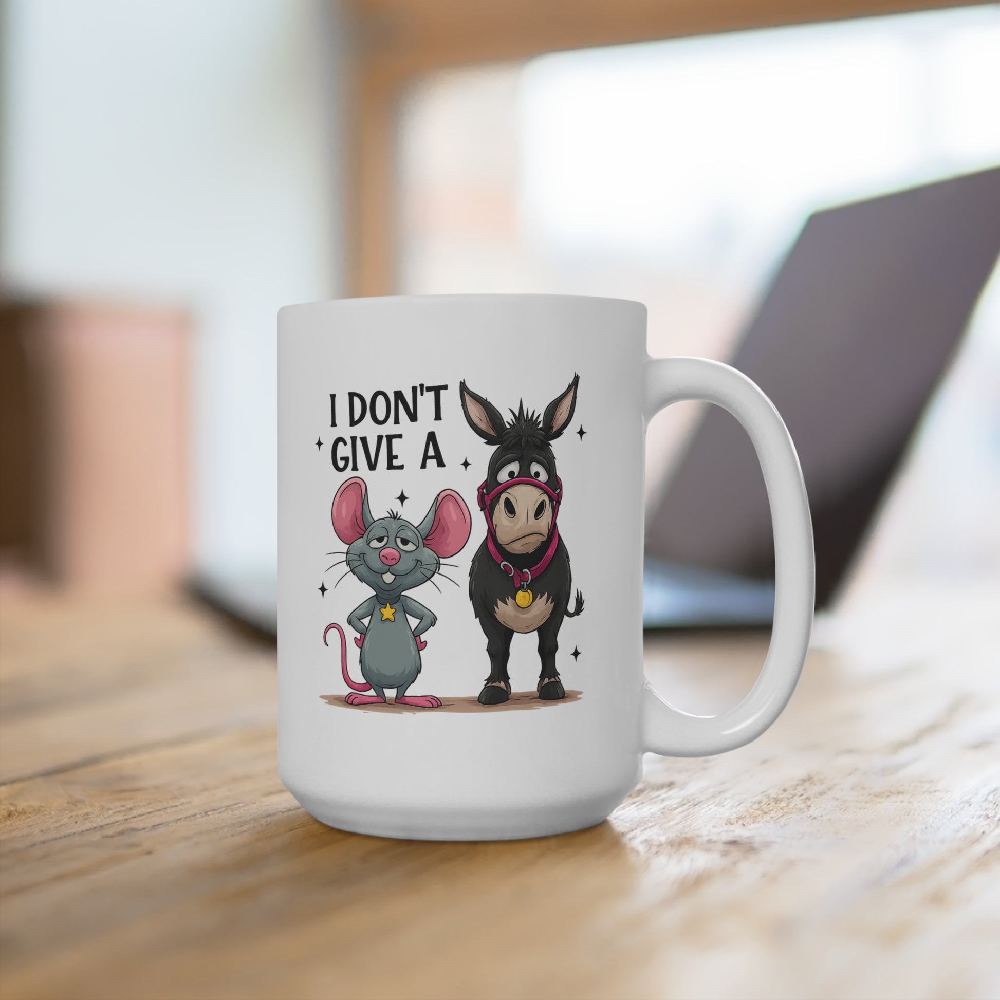 White mug with cartoon mouse and donkey design and text 'I Don't Give A' on a wooden surface.