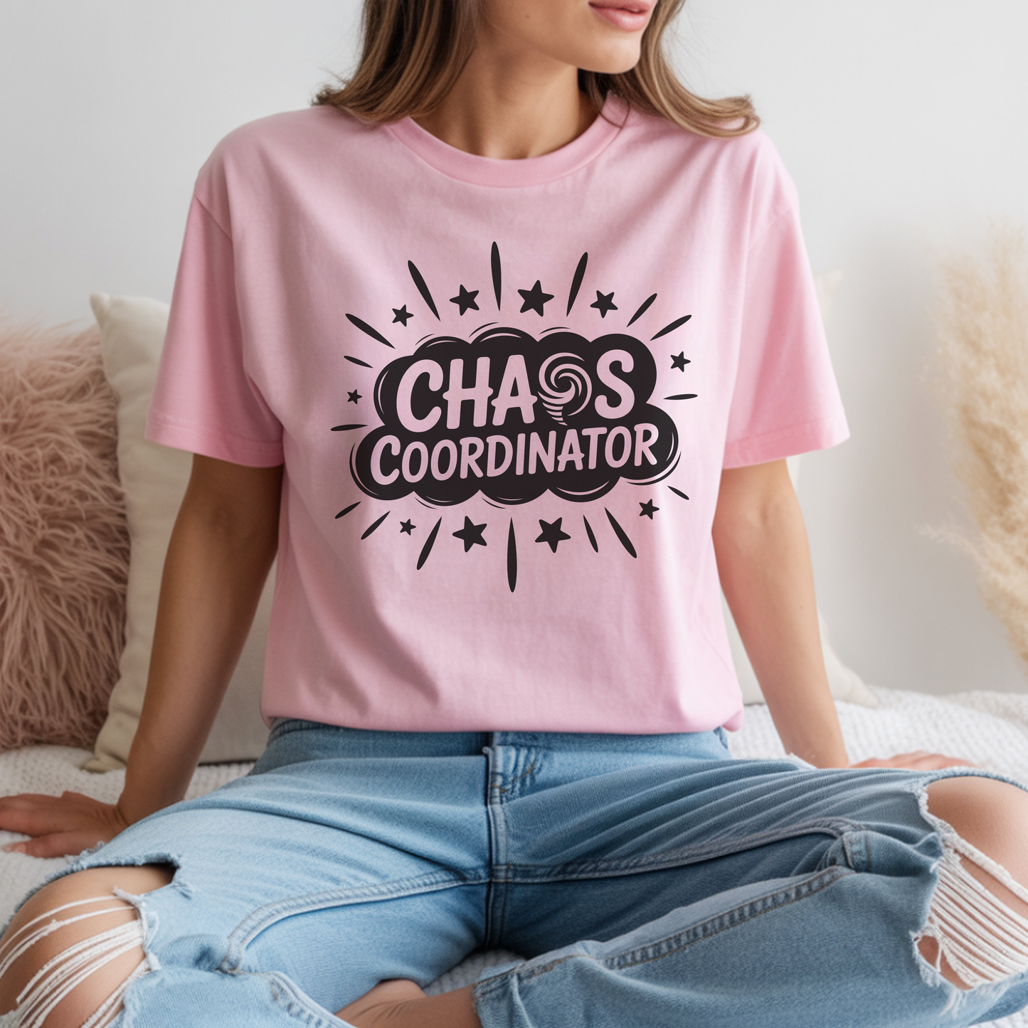 Person wearing a pink t-shirt with 'Chaos Coordinator' text